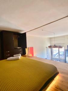 a bedroom with a bed with a yellow bedspread at Abbasaga, Besiktas in Istanbul