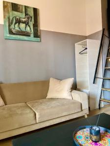 a living room with a couch and a painting of a horse at Abbasaga, Besiktas in Istanbul
