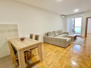 a living room with a couch and a table at Shine apartment in Trebinje