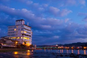 a building next to a body of water at night at caffel Hina-no-sato in Hita