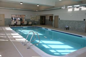 a large swimming pool in a building at Hampton Inn Watertown in Watertown