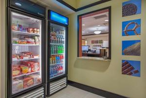 a store with a refrigerator filled with lots of food at Hampton Inn Covington in Covington