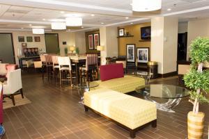 a restaurant with a table and chairs and a dining room at Hampton Inn Atlanta-Fairburn in Fairburn