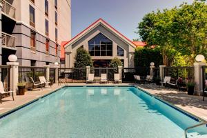 a swimming pool with chairs and a building at Hampton Inn & Suites Atlanta/Duluth/Gwinnett in Duluth