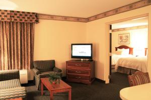 a hotel room with a television and a bed at Hampton Inn & Suites-Atlanta Airport North-I-85 in Atlanta