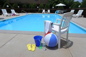 a chair and a beach ball next to a swimming pool at Hampton Inn Hotel Atlanta-Southlake in Morrow