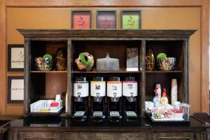 a cabinet filled with bottles of wine on a shelf at Hampton Inn & Suites-Austin Airport in Austin