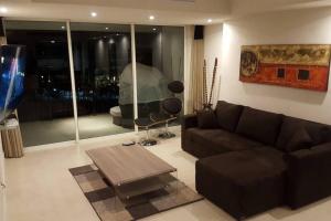 a living room with a couch and a table at Grand Venetian - Zen oceanview condo in hotel zone in Puerto Vallarta