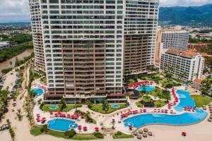 an aerial view of a resort with swimming pools and buildings at Grand Venetian - Zen oceanview condo in hotel zone in Puerto Vallarta