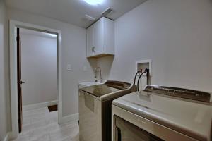 a kitchen with a sink and a stove in it at Quaint Mountainside Splendor in Blue Mountains