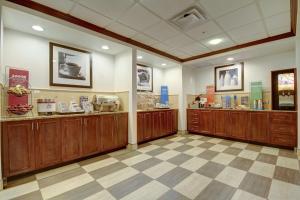 a large room with wooden cabinets in a store at Hampton Inn and Suites Alexandria in Alexandria