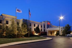 a hotel building with two flags in front of it at Hampton Inn & Suites Kalamazoo-Oshtemo in Oshtemo