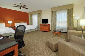 a hotel room with two beds and a living room at Hampton Inn & Suites Buffalo in Buffalo