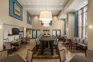 a dining room with a table and chairs at Hampton Inn & Suites Bluffton-Sun City in Bluffton