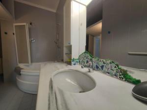 a white bathroom with a toilet and a sink at Casa Mario in Loano +10 photos