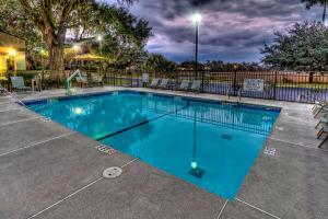 a large swimming pool with blue water at night at Hampton Inn Beaufort in Beaufort