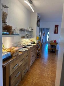 a kitchen with a counter with alot of food on it at Pension Deichblick 1 in Norden +8 photos