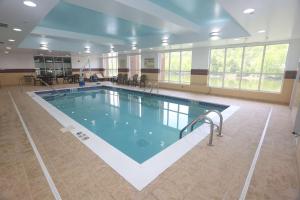 a large swimming pool in a large room at Hampton Inn Owego in Owego