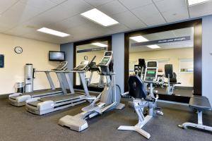 a gym with several treadmills and elliptical machines at Hampton Inn Ellsworth in Ellsworth