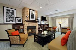 a living room with a couch and a fireplace at Hampton Inn Jasper in Jasper