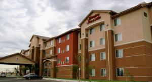 a hotel with a car parked in front of it at Hampton Inn and Suites Bakersfield North-Airport in Bakersfield