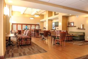 a lobby with chairs and tables and a restaurant at Hampton Inn & Suites Brookings in Brookings