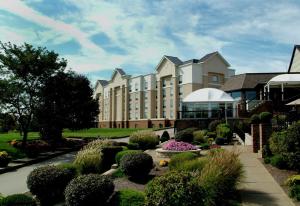 a large building with a garden in front of it at Hampton Inn & Suites Blairsville in Blairsville