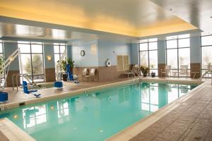 a large swimming pool with blue water in a building at Hampton Inn & Suites Blairsville in Blairsville