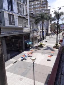 a street with chairs and tables on a sidewalk at Habitación en peatonal de Concordia 25000 PESOS LA NOCHE in Concordia