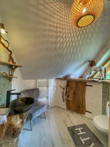 a bathroom with a sink and a toilet in a room at Gliniana Chata in Zawoja