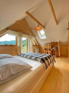 a bedroom with a bed and a window at Gliniana Chata in Zawoja