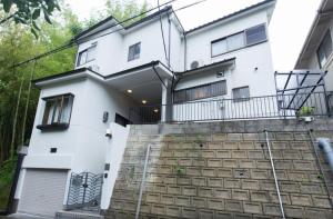a white house with stairs in front of it at Chikuan Kyoto Whole Rental Lodging - Vacation STAY 78789v in Nishi-kujō-Toriiguchichō