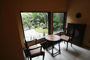 a dining room with a table and chairs and a window at HARUYA Umekoji in Kyoto +46 photos