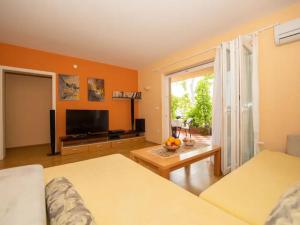 a living room with two beds and a large window at BENCUN apartmani in Makarska