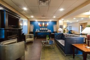 a lobby with a couch and a bar in the background at Hampton Inn & Suites Mount Juliet in Mount Juliet