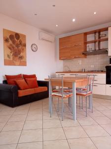 een keuken en een woonkamer met een tafel en stoelen bij BELLISSIMA! CASA BABY - in Massarosa