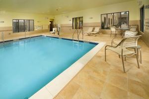 a large swimming pool with chairs and a table at Hampton Inn Haverhill in Haverhill