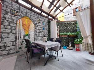a dining room with a table and a stone wall at Leona in Novigrad Istria