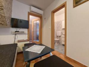 a living room with a table and a television at Leona in Novigrad Istria