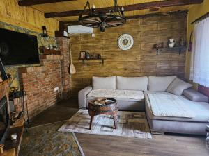 a living room with a couch and a table at Kuća za odmor - Živanić in Ležimir