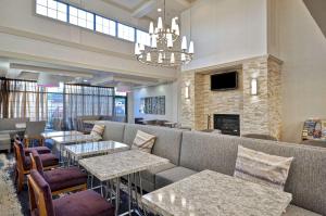 a restaurant with couches and tables and a fireplace at Homewood Suites Boston Peabody in Peabody