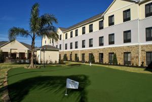 un campo de golf frente a un edificio en Homewood Suites Beaumont, en Beaumont