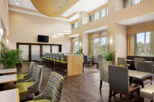 a dining room with a long table and chairs at Hampton Inn & Suites Brunswick in Brunswick
