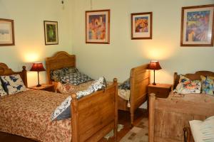 a bedroom with two twin beds and two lamps at King Room bed and breakfast main house in Tanetane