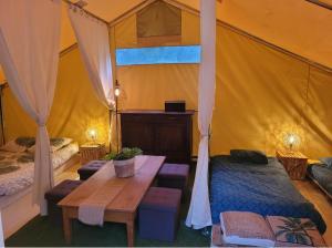 a room with a bed and a table in a tent at Loz'aire naturelle in Quézac