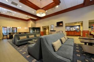 a large living room with couches and a table at Hampton Inn East Aurora in East Aurora