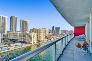 a balcony with a view of the water and buildings at Gorgeous 4 BDRM Condo Stunning Views Beach Access in Hallandale Beach