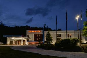 a building with a sign that reads chiropractor clinic at night at Hampton Inn Brevard in Pisgah Forest