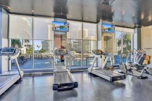a gym with cardio machines and a view of a city at Perfect Vacation 4 Bedroom Condo Beach Access in Hallandale Beach