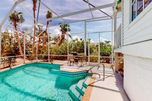 an indoor swimming pool with a large glass wall at Dixie Beach Delight in Sanibel